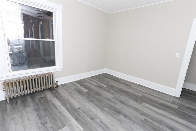 unfurnished room with ornamental molding, dark hardwood / wood-style floors, and radiator