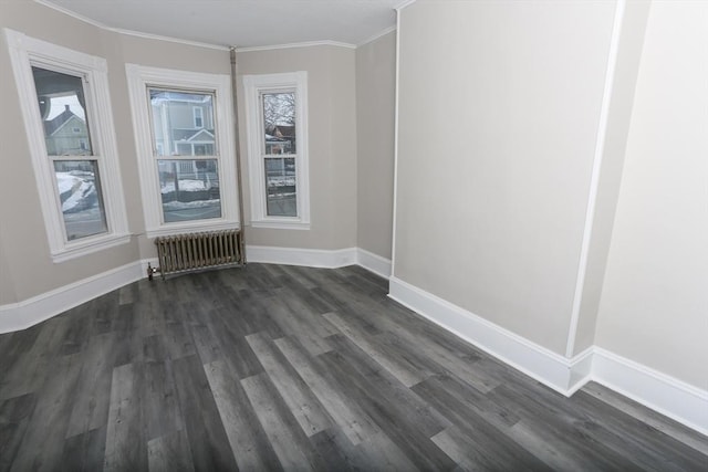 unfurnished room with ornamental molding, radiator, and dark wood-type flooring