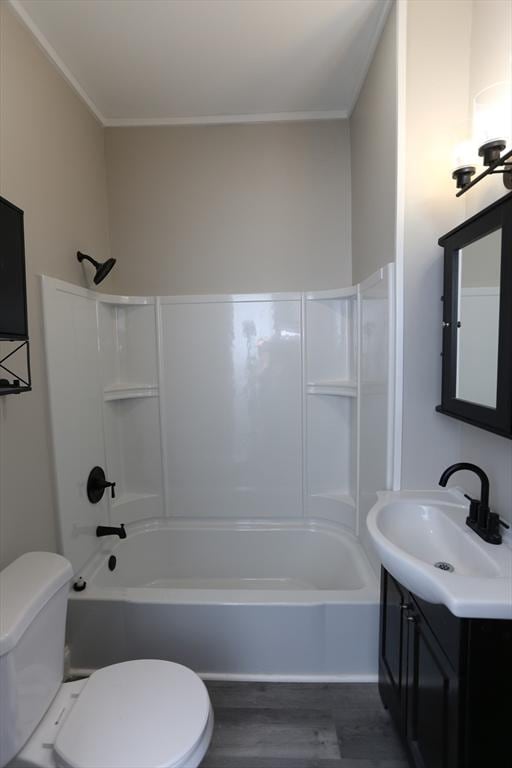 full bathroom featuring tub / shower combination, hardwood / wood-style floors, vanity, ornamental molding, and toilet