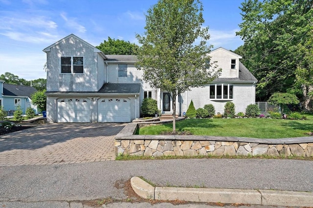 7 Helen Rd, Braintree, MA 02184 - traditional-style home featuring decorative driveway, a garage, and brick siding