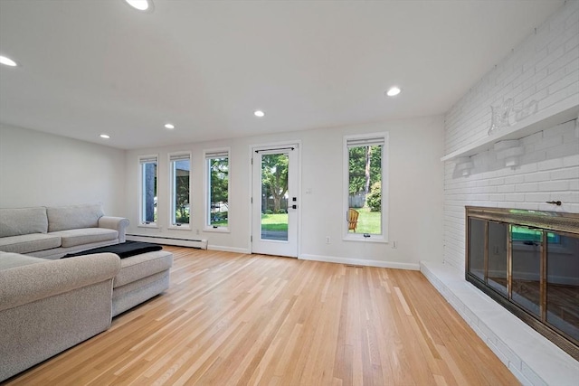7 Helen Rd, Braintree, MA 02184 - living area featuring a baseboard heating unit, light wood-style flooring, recessed lighting, and a brick fireplace