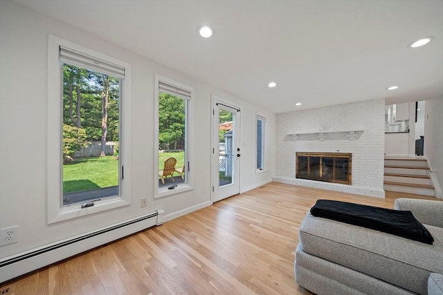 7 Helen Rd, Braintree, MA 02184 - living area with a baseboard radiator, plenty of natural light, wood finished floors, recessed lighting, and a brick fireplace