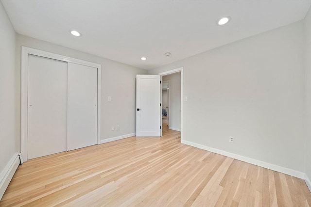7 Helen Rd, Braintree, MA 02184 - unfurnished bedroom with a baseboard radiator, light wood-style flooring, recessed lighting, and a closet