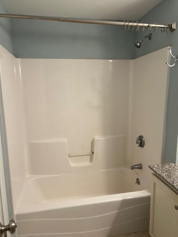 bathroom featuring tile patterned floors, shower / washtub combination, and vanity