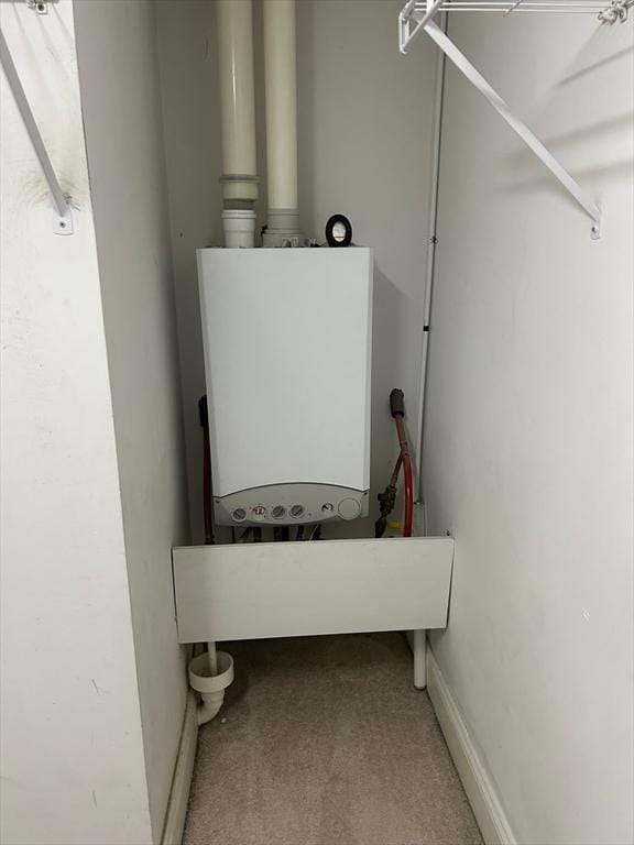 utility room featuring water heater