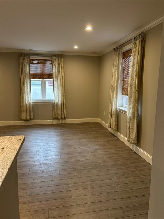 unfurnished room with crown molding and wood-type flooring