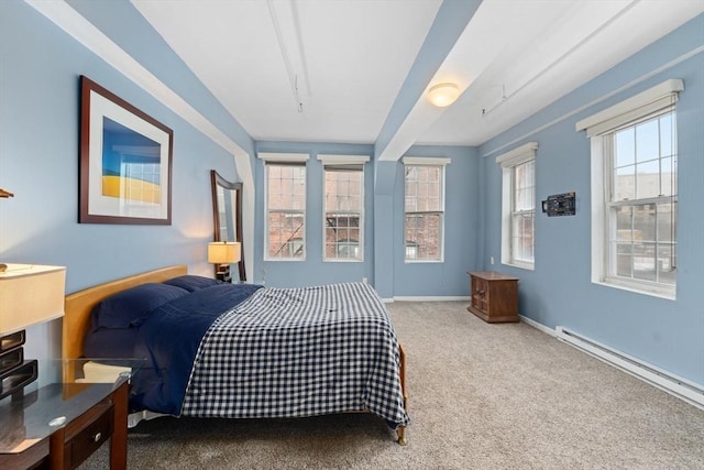 carpeted bedroom featuring baseboards, multiple windows, and baseboard heating