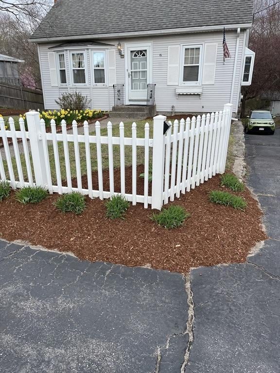 16 Miriam Dr, Attleboro, MA 02703 - cape cod-style house featuring a shingled roof and a fenced front yard