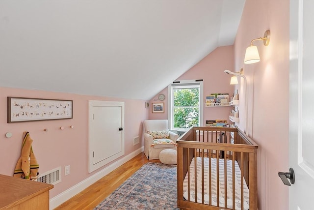 15 Hardy St Unit 2, Salem, MA 01970 - bedroom with vaulted ceiling, wood finished floors, baseboards, and a nursery area
