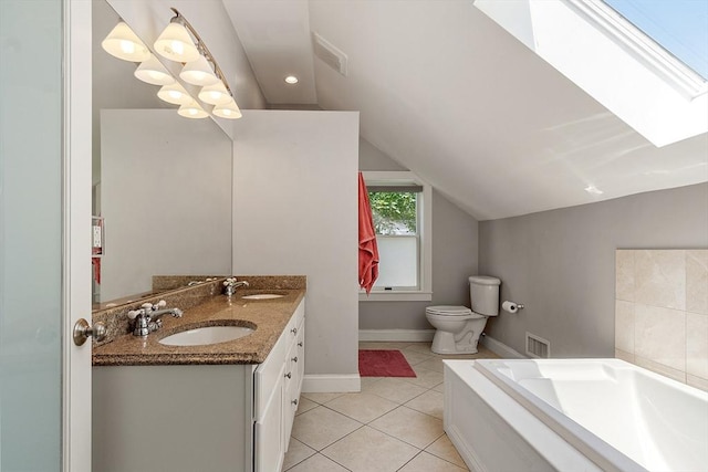 15 Hardy St Unit 2, Salem, MA 01970 - bathroom with a garden tub, double vanity, lofted ceiling, toilet, and tile patterned flooring