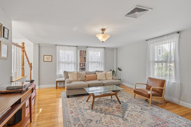 15 Hardy St Unit 2, Salem, MA 01970 - living room featuring healthy amount of natural light, stairway, light wood-style floors, and baseboards