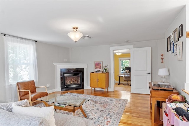 15 Hardy St Unit 2, Salem, MA 01970 - living room featuring light wood-style flooring, a desk, and a glass covered fireplace
