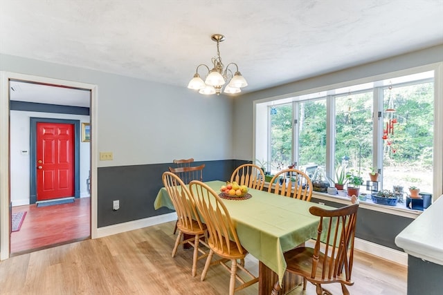 dining room featuring an inviting chandelier and light hardwood / wood-style flooring