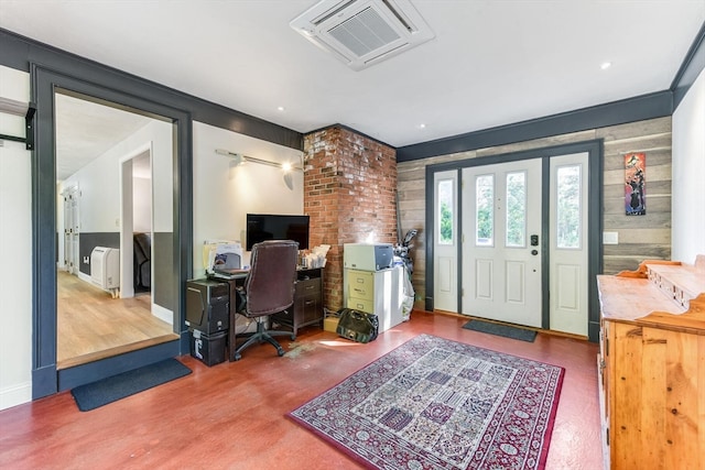 office with wood-type flooring and wood walls