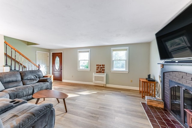 living room with a fireplace, hardwood / wood-style floors, and heating unit