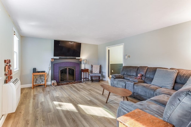 living room with light wood-type flooring and a fireplace