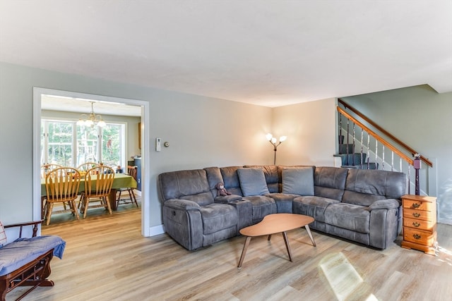 living room featuring light hardwood / wood-style floors and an inviting chandelier