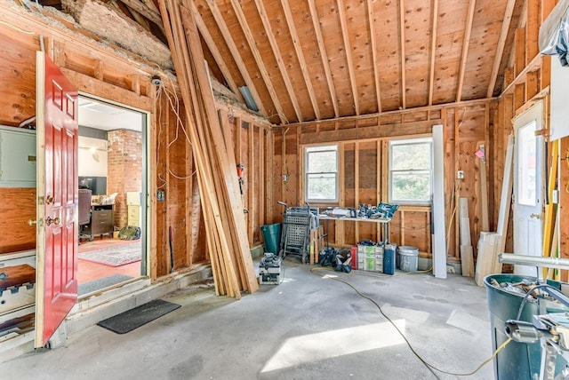 miscellaneous room featuring lofted ceiling and concrete flooring