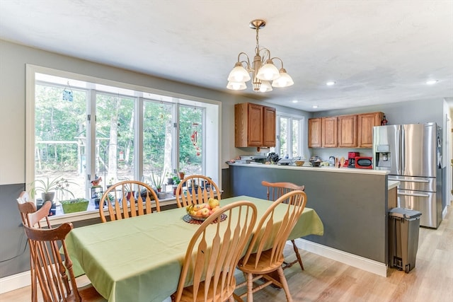 dining room with a chandelier and light hardwood / wood-style floors