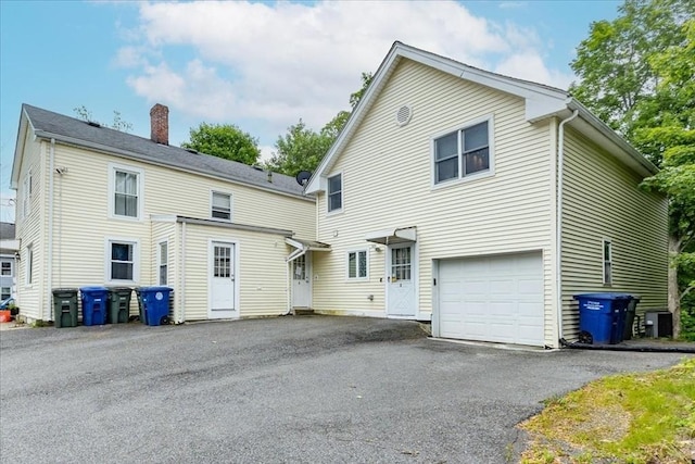 66 Hamilton St Unit 3, Leominster, MA 01453 - back of house featuring a chimney, driveway, and a garage