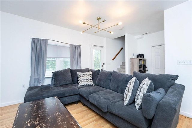 66 Hamilton St Unit 3, Leominster, MA 01453 - living room featuring stairs, a chandelier, light wood-style flooring, and baseboards