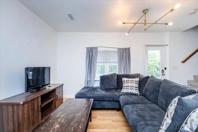 66 Hamilton St Unit 3, Leominster, MA 01453 - living room featuring a chandelier, light wood-style flooring, and baseboards