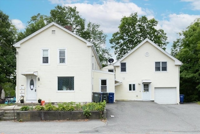 66 Hamilton St Unit 3, Leominster, MA 01453 - view of front of home with asphalt driveway, a chimney, and an attached garage