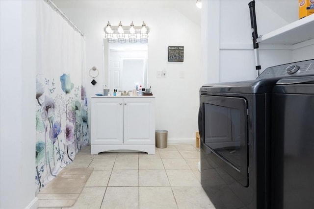 66 Hamilton St Unit 3, Leominster, MA 01453 - laundry room featuring light tile patterned floors, separate washer and dryer, cabinet space, and baseboards