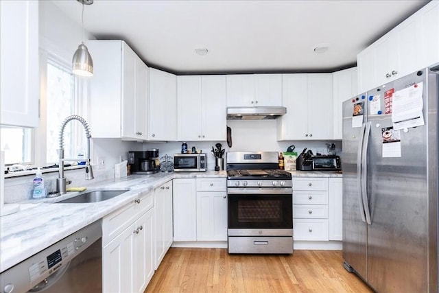 66 Hamilton St Unit 3, Leominster, MA 01453 - kitchen with stainless steel appliances, under cabinet range hood, a sink, and white cabinets