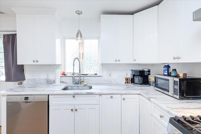 66 Hamilton St Unit 3, Leominster, MA 01453 - kitchen featuring stainless steel appliances, a sink, healthy amount of natural light, and white cabinetry