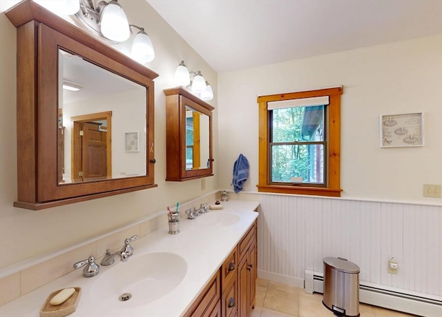 131 Sandgully Rd N, Deerfield, MA 01373 - full bath with a baseboard heating unit, double vanity, a wainscoted wall, and tile patterned floors
