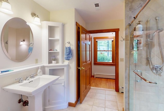 131 Sandgully Rd N, Deerfield, MA 01373 - bathroom with a shower stall, a baseboard radiator, baseboard heating, tile patterned flooring, and built in shelves