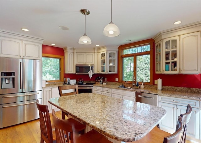 131 Sandgully Rd N, Deerfield, MA 01373 - kitchen with stainless steel appliances, a sink, a kitchen bar, pendant lighting, and recessed lighting