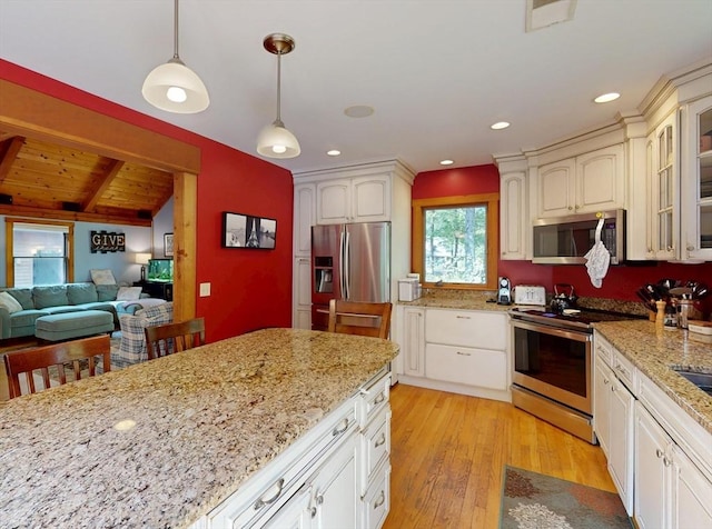 131 Sandgully Rd N, Deerfield, MA 01373 - kitchen with appliances with stainless steel finishes, glass insert cabinets, decorative light fixtures, light wood-style floors, and light stone countertops