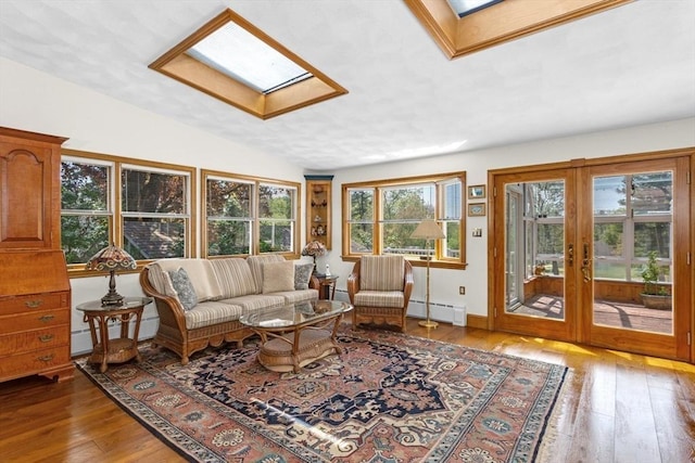 78 Daniels St, Franklin, MA 02038 - living area featuring baseboard heating, a skylight, hardwood / wood-style flooring, and french doors