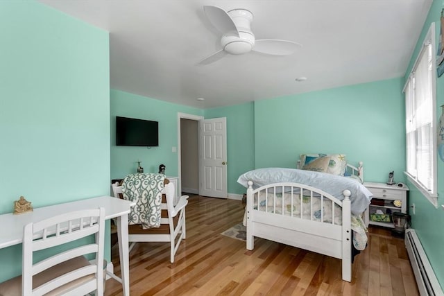 78 Daniels St, Franklin, MA 02038 - bedroom featuring a baseboard heating unit, light wood-type flooring, baseboards, and ceiling fan