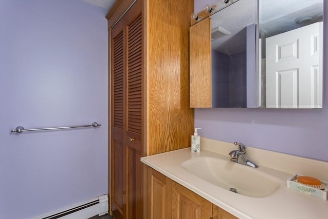 78 Daniels St, Franklin, MA 02038 - bathroom featuring baseboard heating, vanity, and a closet