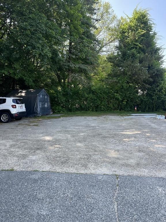 13 Elm St, Webster, MA 01550 - view of parking / parking lot with a storage unit