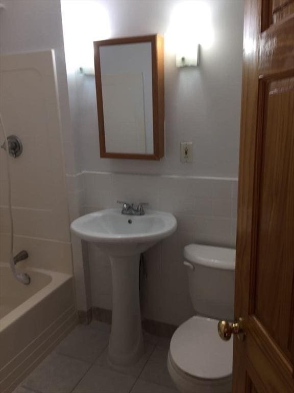 13 Elm St, Webster, MA 01550 - full bathroom featuring tile patterned flooring, shower / bath combination, a wainscoted wall, and tile walls