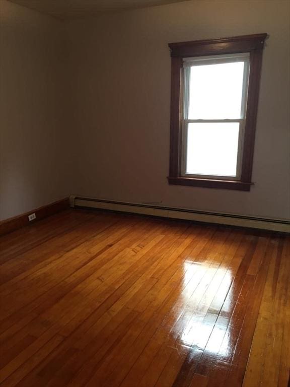 13 Elm St, Webster, MA 01550 - unfurnished room featuring baseboard heating and dark wood-style flooring