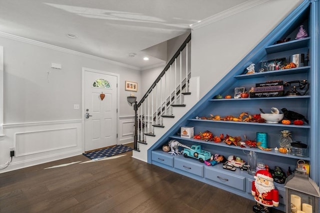 foyer entrance with dark wood-type flooring and ornamental molding