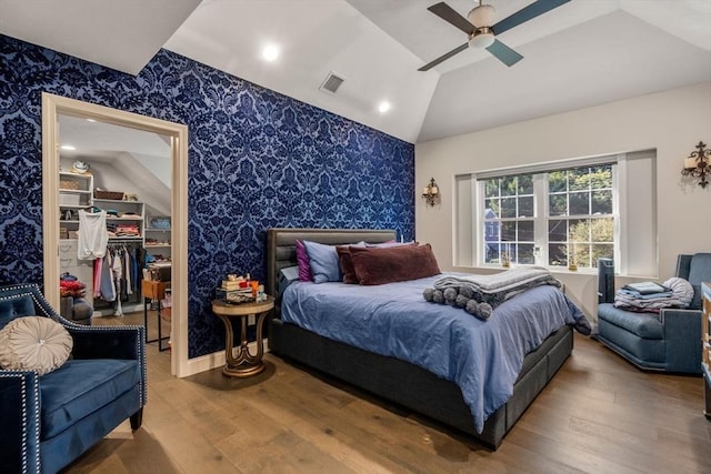 bedroom with ceiling fan, hardwood / wood-style flooring, a closet, and vaulted ceiling