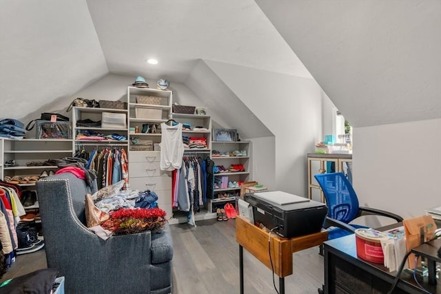 walk in closet with vaulted ceiling and wood-type flooring