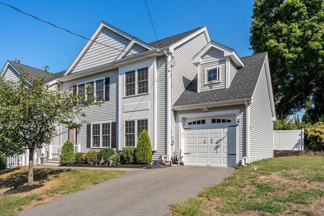 view of front of home featuring a garage and a front lawn