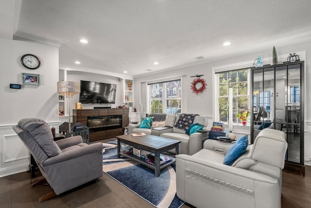 living room with ornamental molding and dark hardwood / wood-style floors