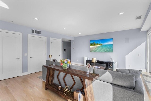 living room featuring light wood-type flooring and recessed lighting