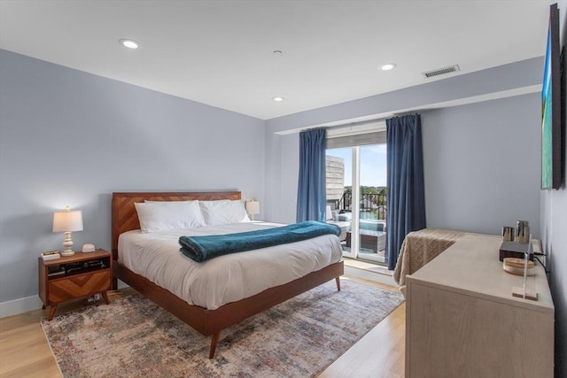 bedroom featuring access to outside, light wood-style flooring, recessed lighting, and baseboards
