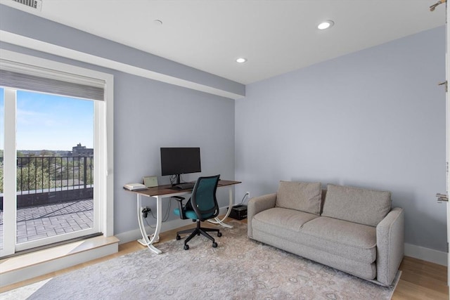 office featuring baseboards, wood finished floors, and recessed lighting