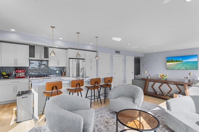 living area with light wood-style floors and recessed lighting