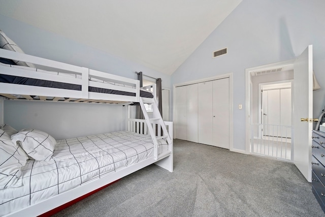 carpeted bedroom featuring high vaulted ceiling and a closet